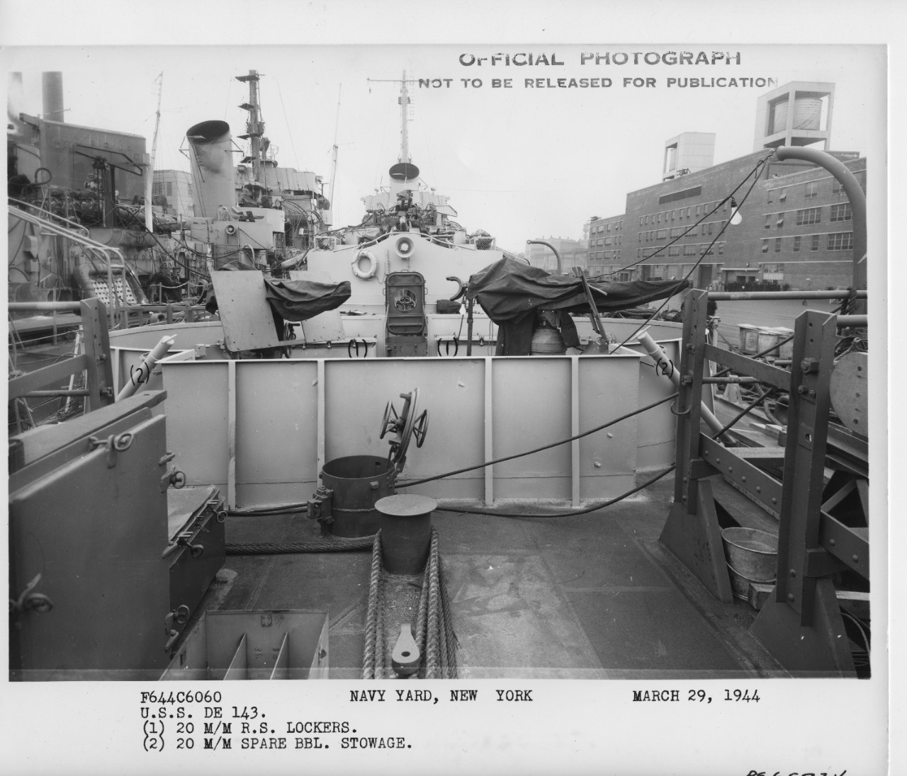 Looking forward from Fiske’s fantail, 29 March 1944, with Durant alongside (L), the latter festooned with lines and cables that typify a shipyard overhaul. Note Fiske’s after 20-millimeter mounts; number (1) refers to ready service boxes for 20-millimeter ammunition, while (2) refers to spare Oerlikon barrel stowage. Also note 3-inch/50 caliber gun just forward. (U.S. Navy Bureau of Ships Photograph BS 65724, National Archives and Records Administration, Still Pictures Division, College Park, Md.)