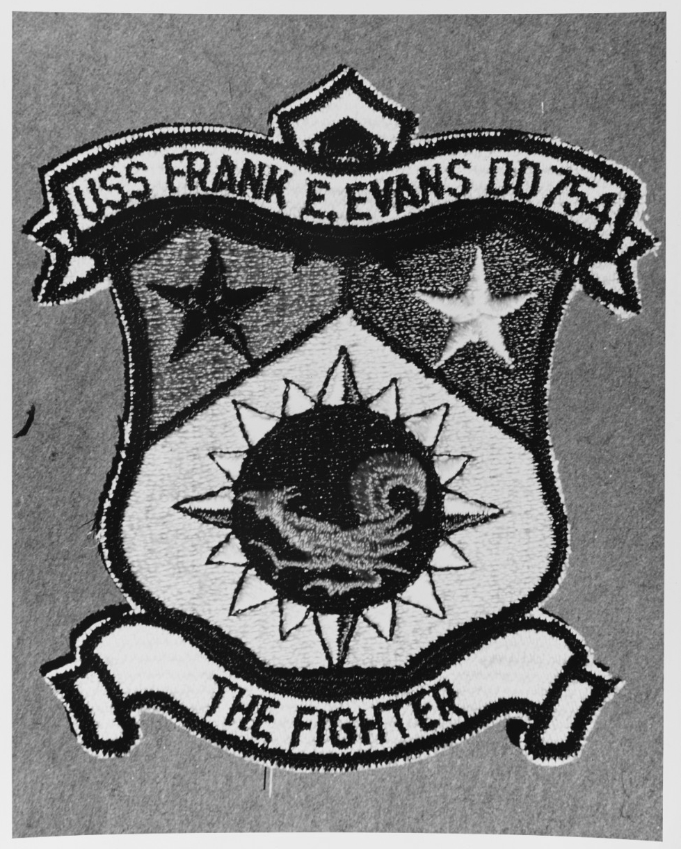 Frank E. Evans displayed this emblem in the later 1960s. The motto “The Fighter” reflects the association of the ship’s namesake with the Marine Corps. (Naval History and Heritage Command Photograph NH 67261-KN)