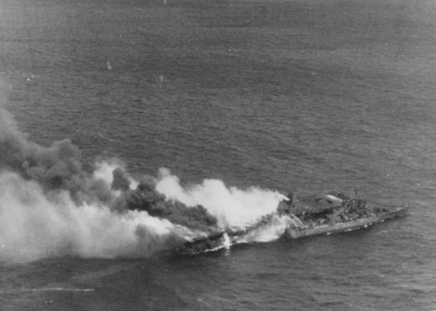 Franklin, dead in the water and burning furiously following the air attack on 19 March 1945. Note, Santa Fe (CL-60) alongside her assisting in the evacuation. (U.S. Navy Photograph 80-G-373734, National Archives and Records Administration, Still ...