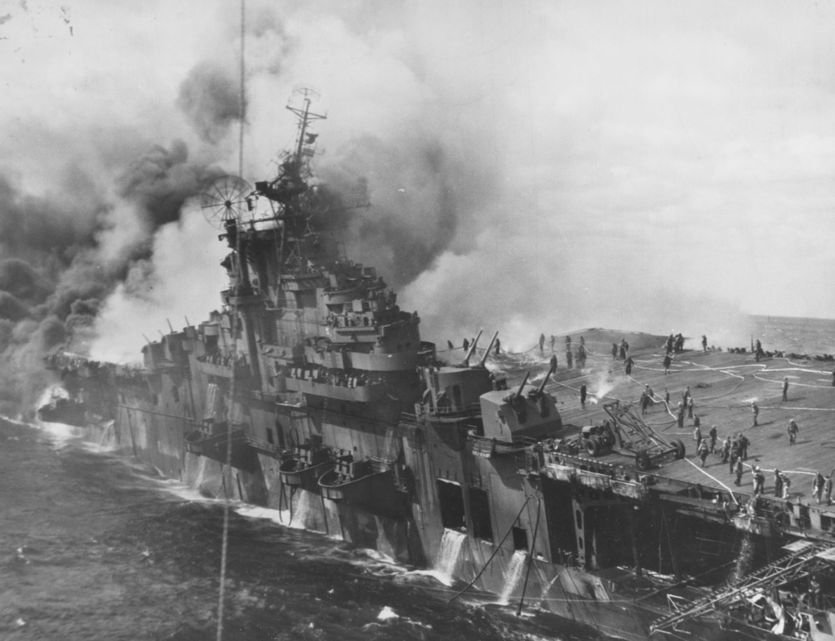 Franklin, on fire and listing badly after being bombed on 19 March 1945. Note the fire hoses and numerous crewmen on her forward flight deck battling the fires. Water also streams from her hangar deck. (U.S. Navy Photograph 80-G-273882, National ...