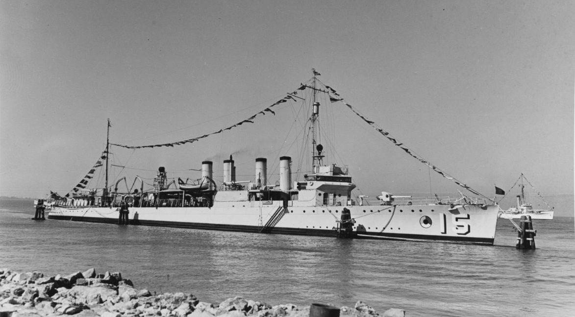 Gamble (DM-15) dressed with flags while tied up in port, circa 1940. Note circular Mine Force insignia, red/blue/white with a black center and outline. Courtesy of the Mariners Museum, Newport News, Virginia. Ted Stone Collection. (Naval History and Heritage Command Photograph NH 66812)