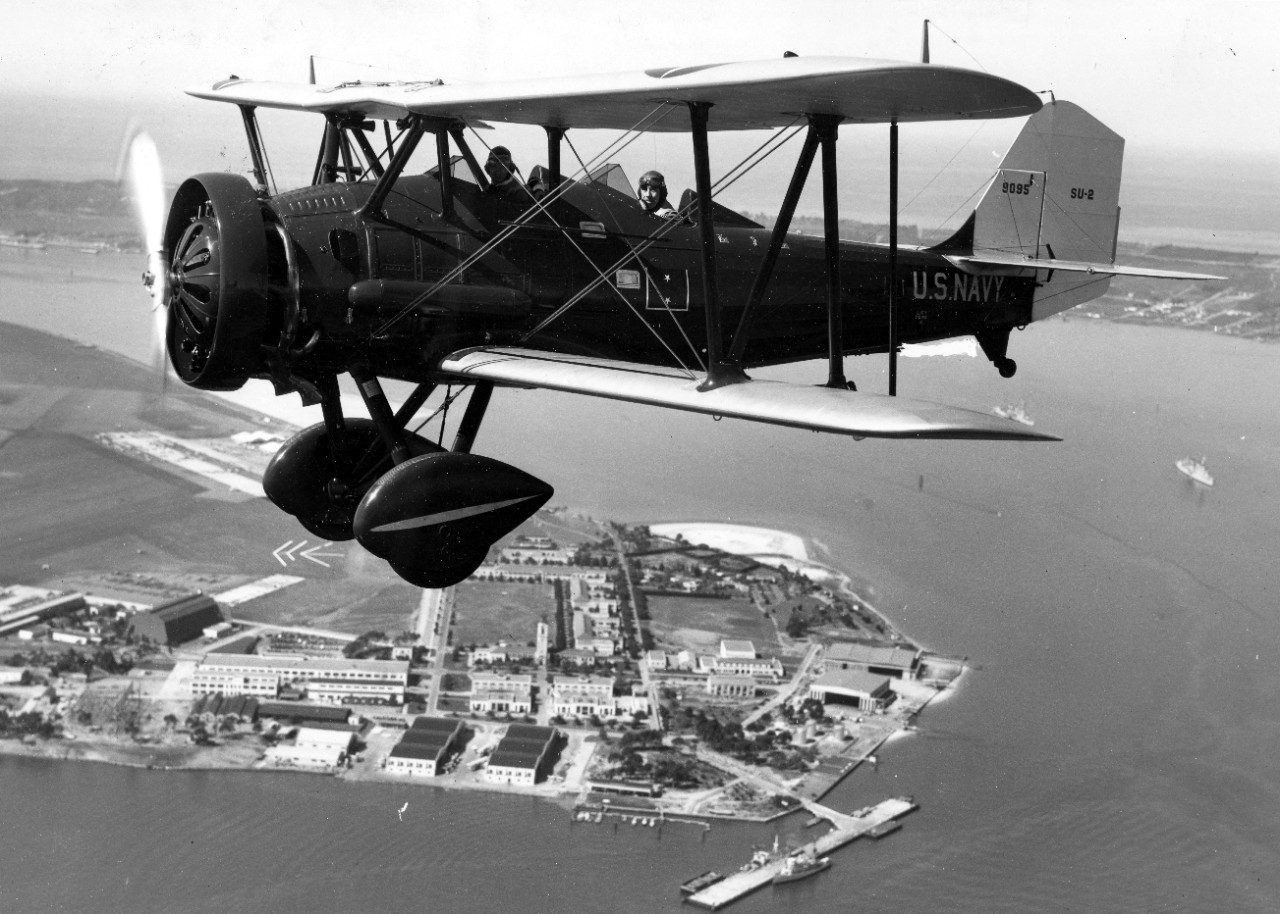 Halligan aloft, as a passenger in the rear seat of a Vought SU-2 (BuNo 9095) over NAS San Diego, 1 March 1934. Note rear admiral’s two-star placard on the side of the aircraft. (U.S. Navy Photograph 80-G-423342, National Archives and Records Admi...