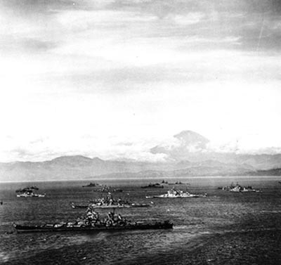 APA-106-7: Mount Fujiyama rises beyond U.S. and British warships in Sagami Wan