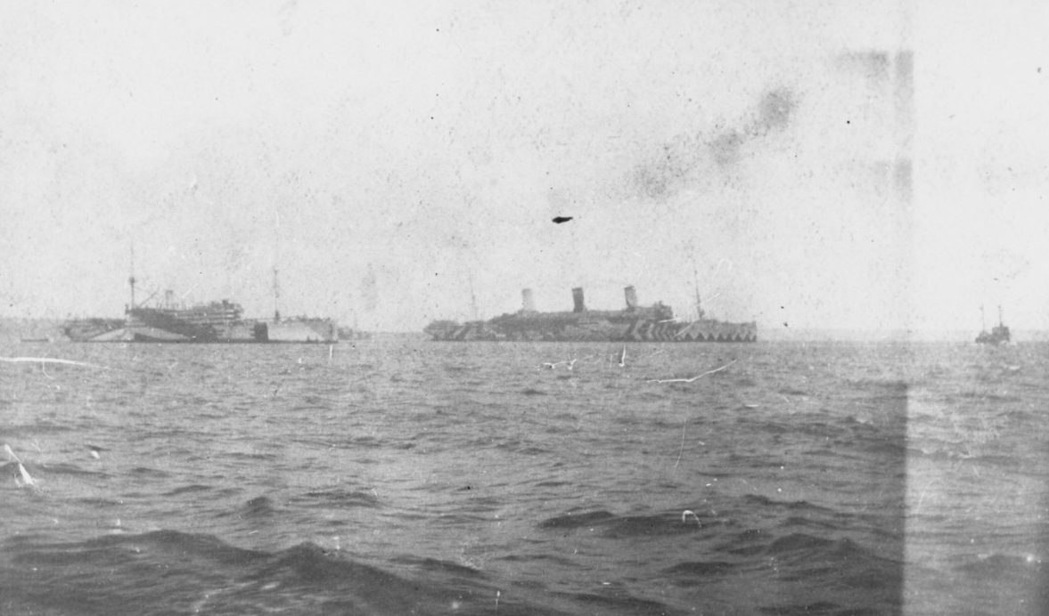 Henderson, left, and Leviathan (Id. No. 1326), center, circa May 1918, probably at Brest, France. Note both ships' dazzle camouflage. (Naval History and Heritage Command Photograph NH 105585)
