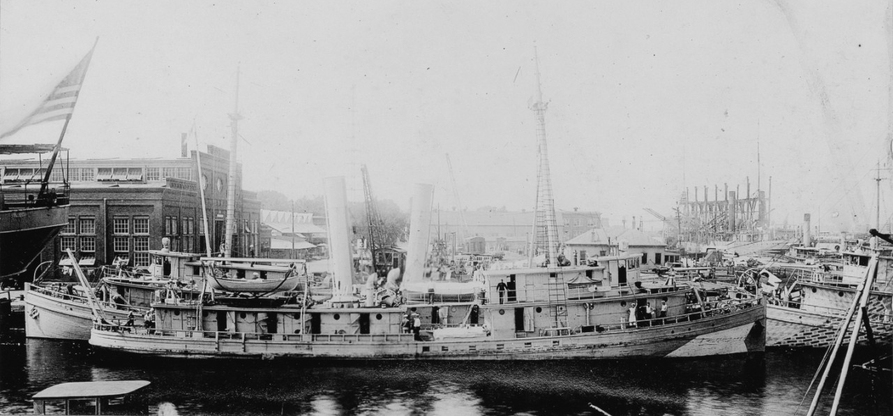 Hubbard fitting out at the bustling Norfolk Navy Yard, painted in one example of disruptive camouflage. Note at least two other Menhaden Fishermen in this view, and a collier visible in the distance at right. (Naval History and Heritage Command Photograph NH 99079)