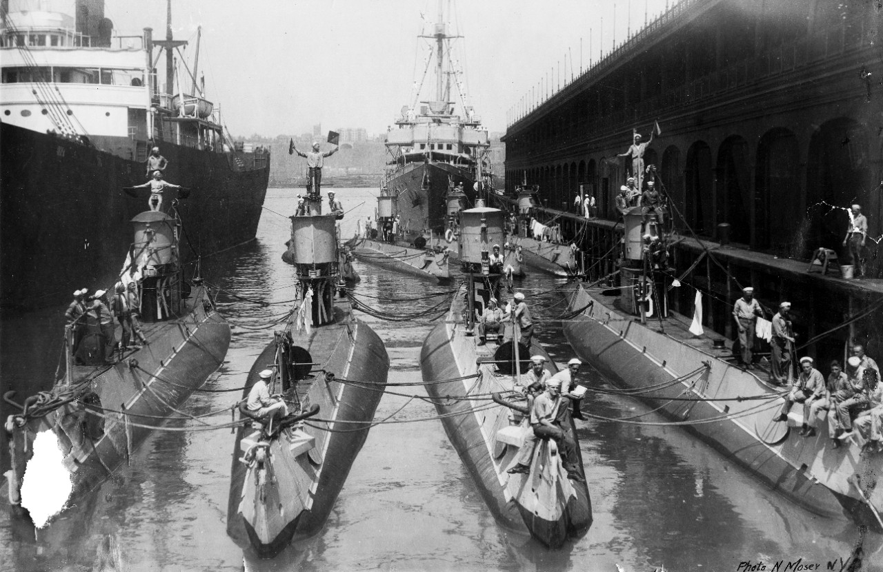 K-Class submarines at New York, N.Y., circa 1920s. Present are K-7 (Submarine No. 38), K-1 (Submarine No. 32), K-5, K-3 (Submarine No. 34) in the foreground with K-2 (Submarine No. 33), K-8 (Submarine No. 39) & K-4 (Submarine No. 35) beyond. Note semaphore flags. (Naval History and Heritage Command Photograph S-551-B.01)