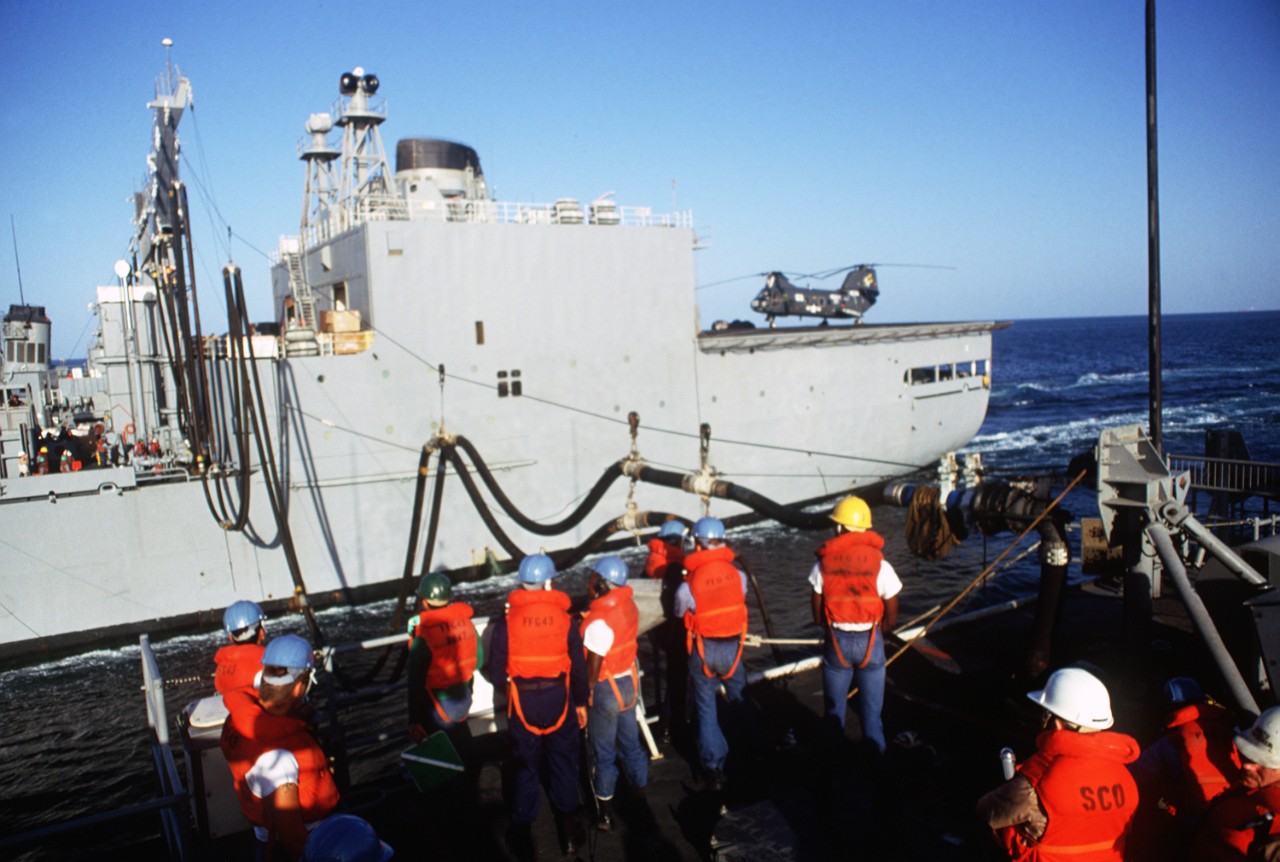 Crew members stand by at the refueling station of guided missile frigate Thach (FFG-43) during an underway replenishment with Kansas City in the Persian Gulf, November 1987. (U.S. Navy Photograph DN-ST-88-02720, PH1 Chuck Mussi, National Archives and Records Administration, Still Pictures Division, College Park, Md.)