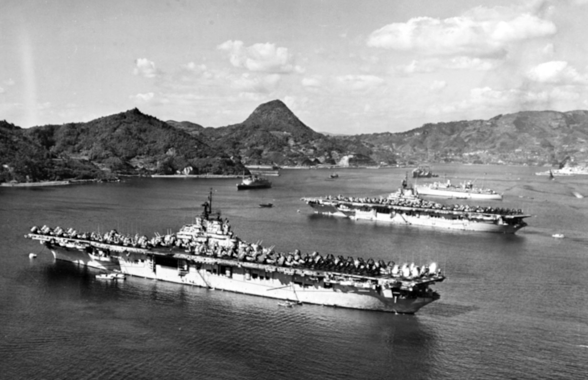 Valley Forge (CV-45) and Leyte moored at Sasebo, Japan, in October 1950. Repair ship Hector (AR-7) lies moored beyond the two carriers, with other U.S. and British warships in the distance. (U.S. Navy Photograph 80-G-426270, National Archives and...