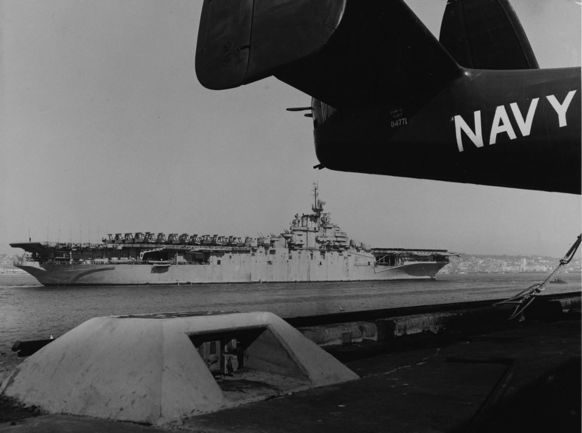 Leyte -- partially framed by the tail of a Martin PBM-5 Mariner (BuNo 84771) -- rounds NAS North Island, as she arrives at San Diego, 3 February 1951. (Naval History and Heritage Command Photograph NH 97296)