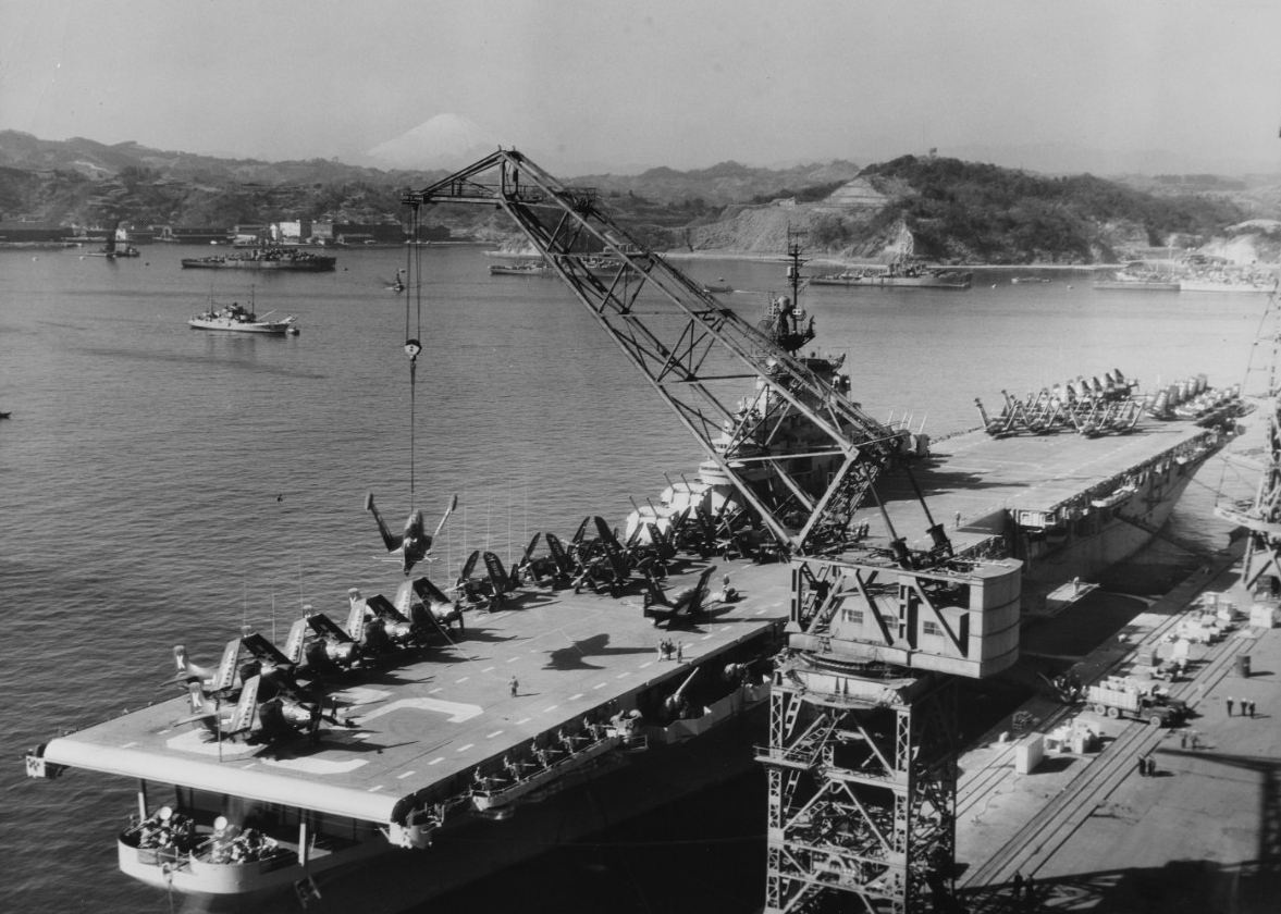 Leyte loading aircraft at Yokosuka for transportation to the U.S., at the end of her Korean War combat tour, 24 January 1951. (Naval History and Heritage Command Photograph NH 97295)
