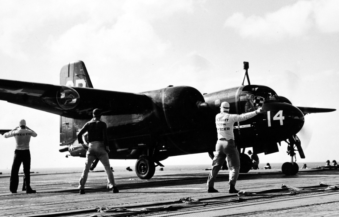 Grumman S2F-1 Tracker antisubmarine aircraft gets a 'go' signal from the Leyte flight deck officer as she is launched for antisubmarine patrol during LANTPHIBEX. The specially-designed aircraft were kept flying around the clock during the oversea...