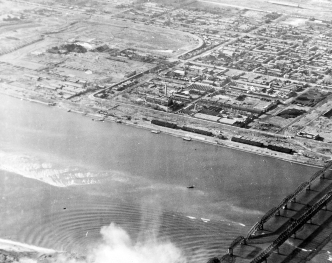Bridges at Sinuiju, North Korea, under attack by planes from Leyte. The built-up area in the background is the Manchurian city of Antung. Bomb explosions in the lower part of the photo are on the Korean side of the Yalu River. Photograph is dated 22 November 1950, but may have been taken on 14 November. (U.S. Navy Photograph 80-G-423492, National Archives and Records Administration Still Pictures Division, College Park, Md.)