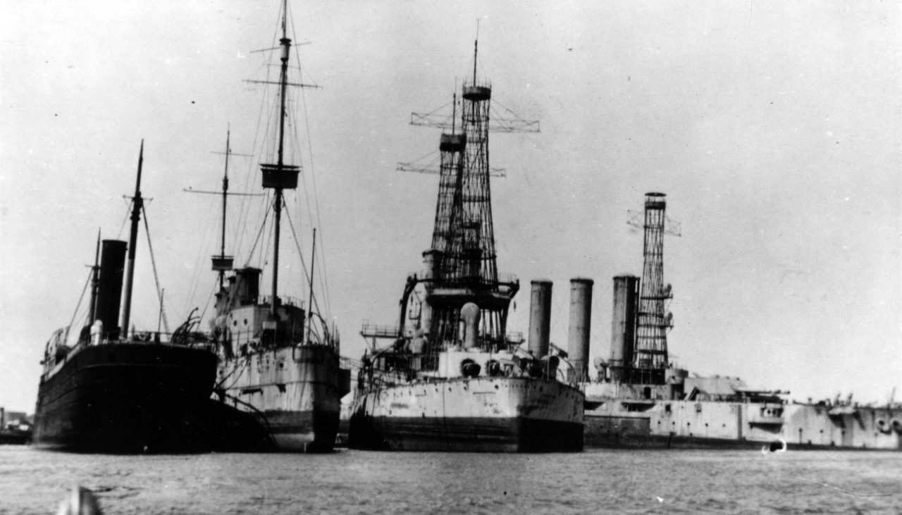 A view of some of the ships scrapped at Philadelphia, circa 1922. Maine lies on the right, down by the head with her side armor removed. Wisconsin is in the center, and Old Columbia, ex-heavy cruiser Columbia (CA-16), to the left, with a merchantman moored alongside. (Naval History and Heritage Command Photograph NH 100762)