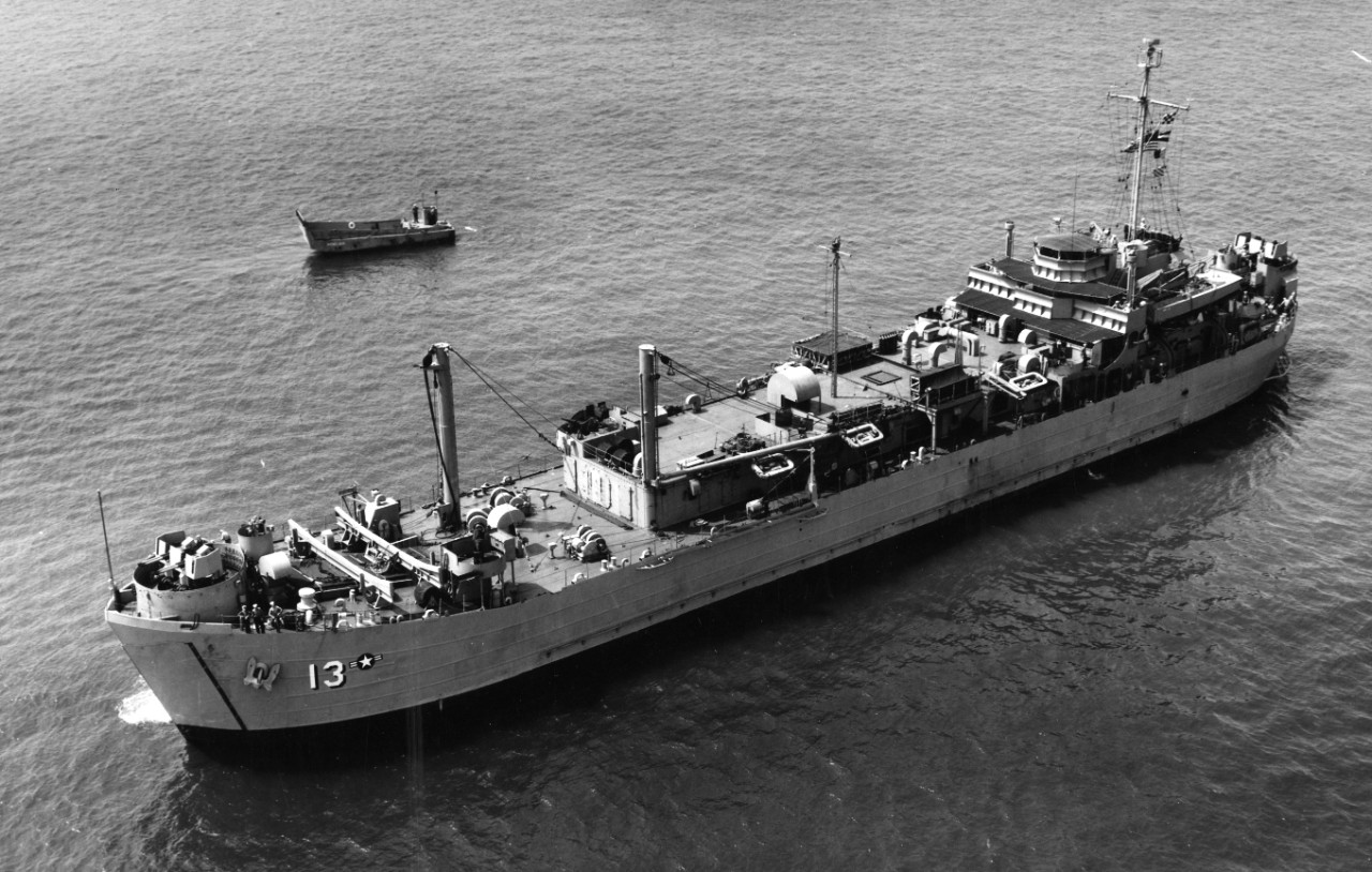Her tank landing ship ancestry plainly visible, Menelaus lies off Norfolk, 31 July 1951, her aviation affiliation indicated by the small national insignia (identical to that displayed on aircraft) painted just aft of her identification number. Cl...