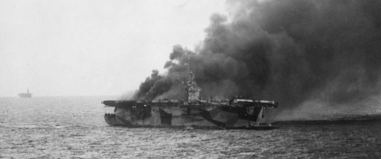 As the uncontrollable fires gain headway, St. Lo slows to a stop and she is abandoned in an orderly manner. Note the men going down the lines into the water. (U.S. Navy Photograph 80-G-270511, National Archives and Records Administration, Still Pictures Division, College Park, Md.)