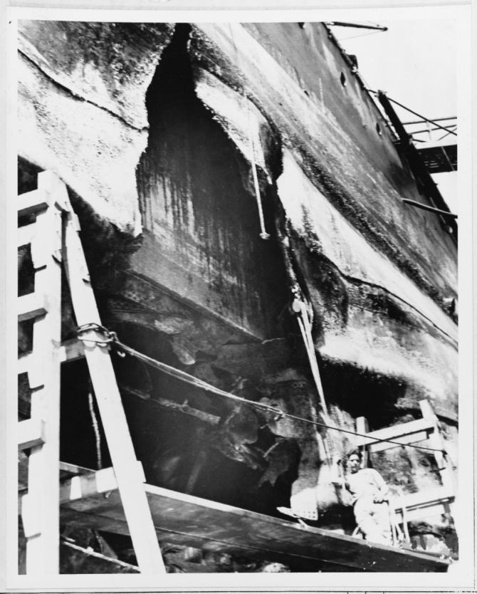 Hole in the ship's port side, between about Frame 38 and Frame 46, caused by a Japanese Type 91 aerial torpedo that hit her during the 7 December 1941 air raid. Photographed about 19 February 1942. The battleship's side armor is visible inside the hole's upper section. (Naval History and Heritage Command Photograph NH 64306)