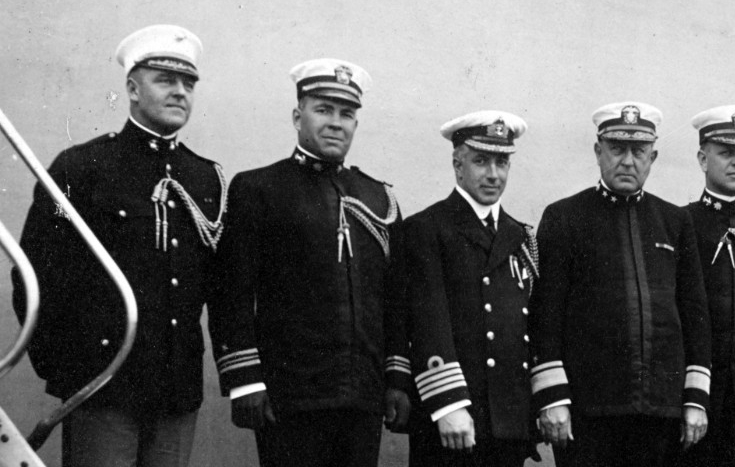 Commander, Sixth Battle Squadron and his staff. The following staff members are pictured on board New York on 1 May 1918. From left to right, Maj. Nelson P. Vulte, USMC; Lt. Cmdr. Jonas H. Ingram; Capt. N.E.F. Aylmer, RN; Rear Adm. Rodman; Cmdr. Husband E. Kimmel; Cmdr. E. W. Money, RN; Lt. Chauncey A. Lucas; and Lt. Harold Dodd. (Naval History and Heritage Command Photograph NH 52739)