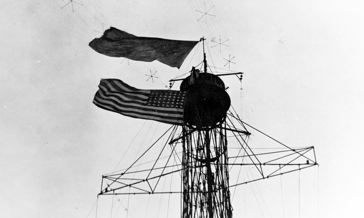 The British royal standard flies from New York’s masthead during the visit of King George V to the ship in 1918. Note mast details and radio antenna. Courtesy of Vice Adm. John L. McCrea, USN (Ret.), 1975. (Naval History and Heritage Command Photograph NH 82929)