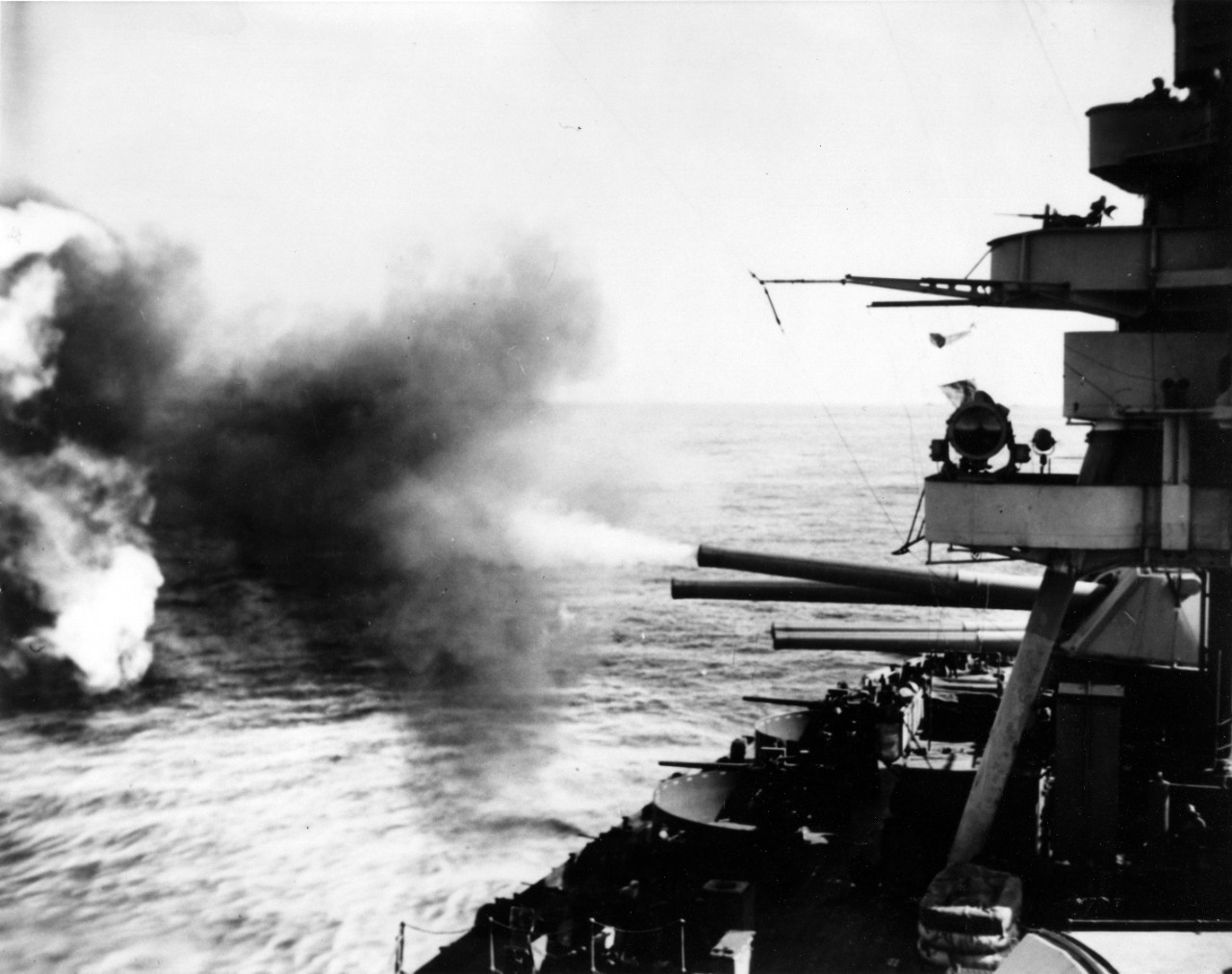 New York bombarding Japanese defenses on Iwo Jima, 16 February 1945. She has just fired the left-hand 14/45 gun of Turret IV. View looks aft, on the starboard side. (U.S. Navy Photograph 80-G-308952, National Archives and Records Administration, Still Pictures Division, College Park, Md.)
