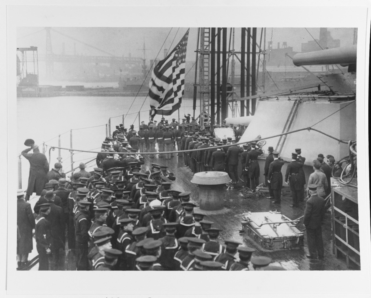 The National Ensign is raised at New York's stern during her commissioning ceremonies, 15 April 1914, at the New York Navy Yard, Brooklyn, N.Y. Courtesy of the Naval Historical Foundation, 1975. (Naval History and Heritage Command Photograph NH 83711)