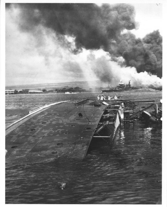 Oglala lies on her side following the devastating Japanese attack at Pearl Harbor, T.H., on 7 December 1941. (Unattributed U.S. Navy Photograph 80-G-32537, National Archives and Records Administration, Still Pictures Branch, College Park, Md.)