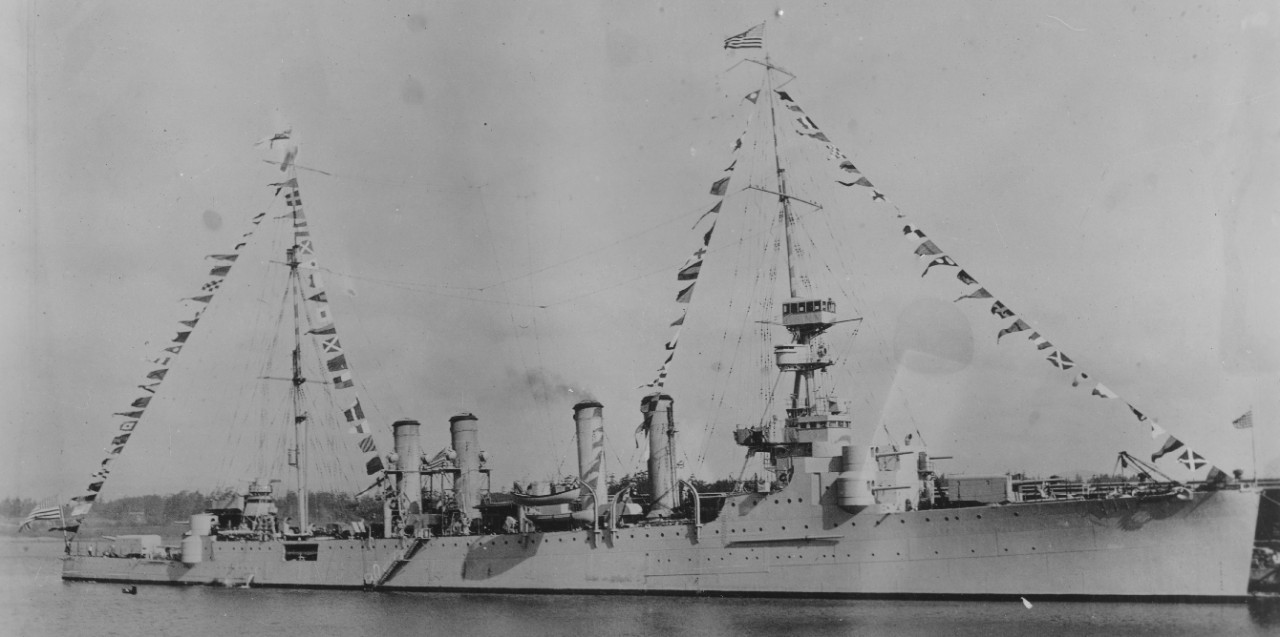 Flying the stars and stripes at the fore and the White Ensign at the main, Omaha lies moored dressed overall, Victoria, British Columbia, 24 May 1923. Photograph by the Browne [or Brown’s] Studio. (U.S. Navy Bureau of Ships Photograph 19-N-9180, ...