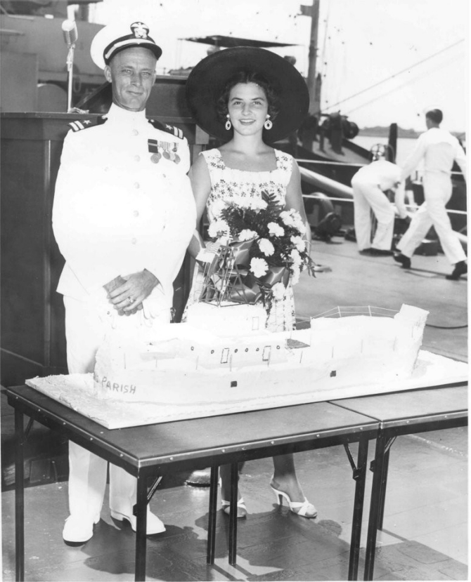 Lt. Robert W. Norville, Orleans Parish’s commanding officer, and former Miss New Orleans Sue Riggs during the ship’s naming ceremony in 1955. (U.S. Navy photograph).