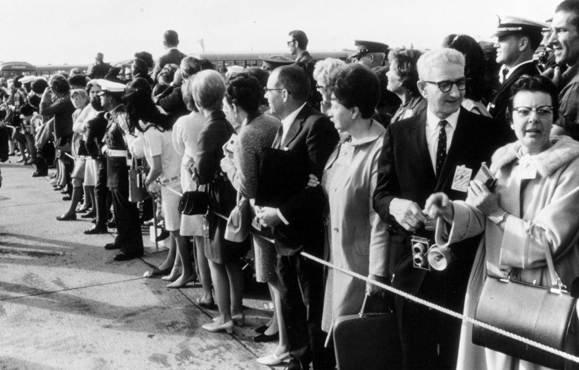 Families, friends, and Navy representatives eagerly await the Starlifters’ arrival at Miramar, 24 December 1968. (PHC V. O. McColley, Naval History and Heritage Command Photograph K-67365)