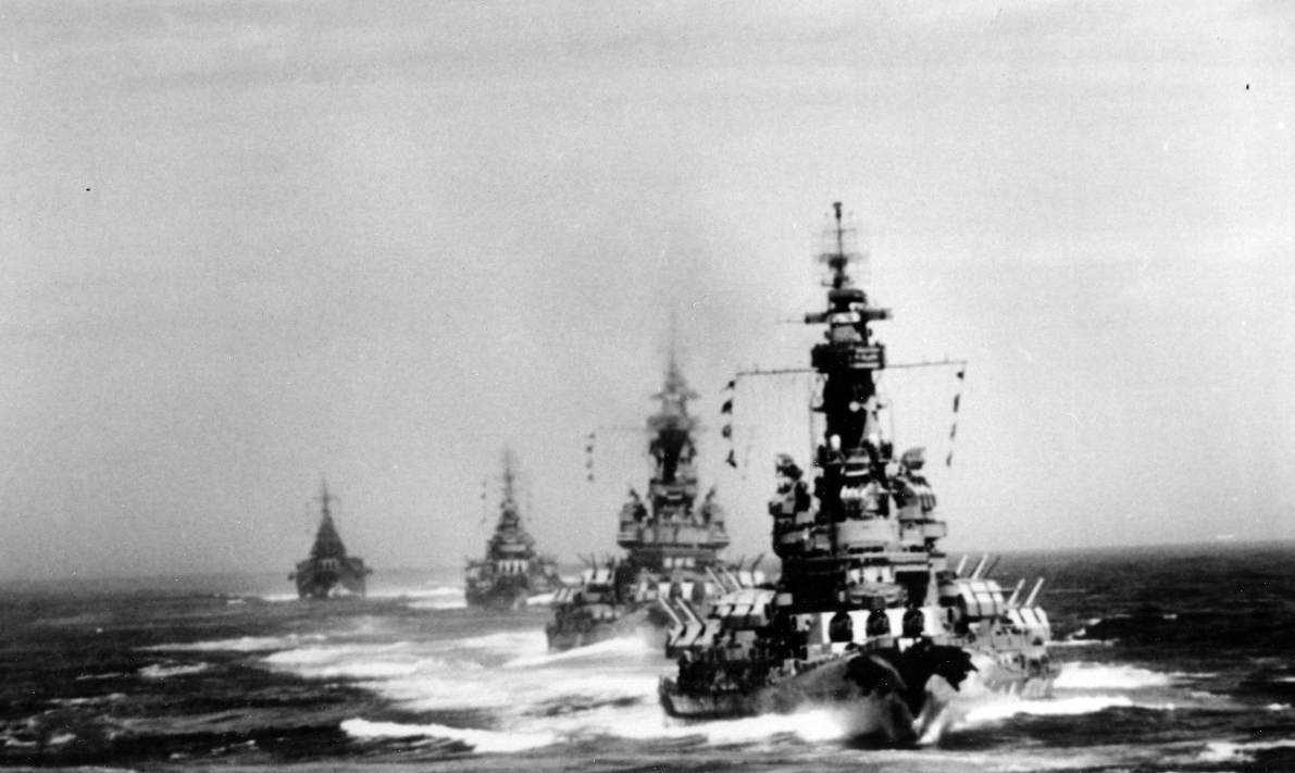 A view aft from South Dakota shows some of the other ships in the column, with Indiana followed by Massachusetts, Quincy, and Chicago (in order), as they unleash their firepower against the Japanese homeland, 14 July 1945. (U.S. Navy Photograph 8...