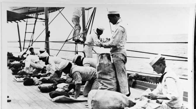 Crewmen prepare their seabags for uniform inspection, circa 1914. (U.S. Navy Photograph NH 85067, Collection of Paul F. Wangerin, Photographic Section, Naval History and Heritage Command)