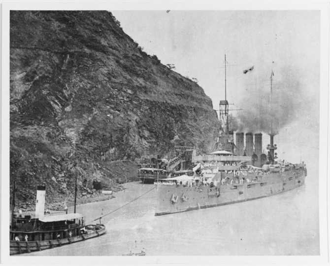 Tennessee in tow of tug Mariner in the Panama Canal, circa 1910. Note the dredge in the center background. (U.S. Navy Photograph NH 76320, Courtesy of Leonard R. Efrein, Photographic Section, Naval History and Heritage Command)
