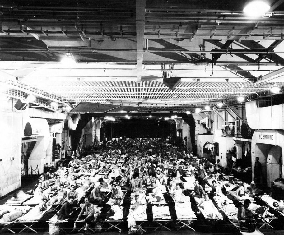 White Plains concludes her wartime service by returning veterans on the crowded hangar deck during Operation Magic Carpet, late 1945. (White Plains (CVE-66), Ships History, Naval History and Heritage Command)