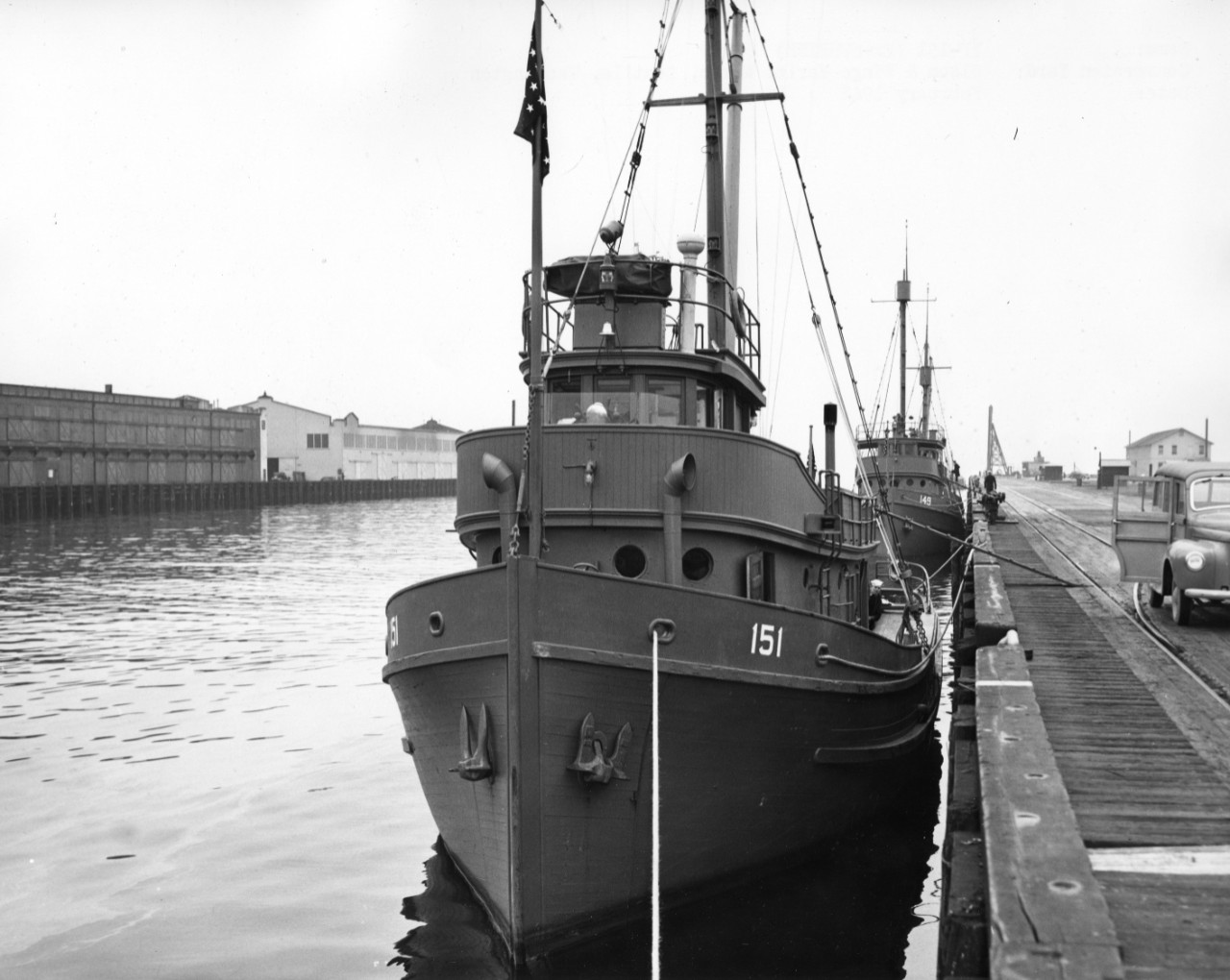 YP-151 (ex-Sunrise) pierside during her conversion in February 1942, with YP-149 (ex-Farallon) moored astern. Note style of her identification number, curious (or perhaps suspicious) sailor looking forward at the photographer from behind the deck...