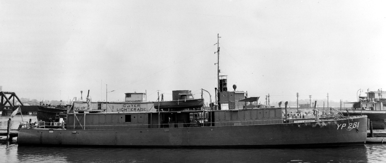 A broadside view of YP-261 showing her appearance at the conclusion of her conversion at Colonna’s Shipyard, circa April 1942. Note YP-261’s main battery of two .50-caliber Browning machine guns, one forward and the second aft on a platform built...