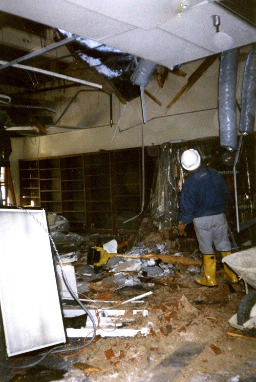 Aftermath of the chimney falling through the roof of the reference room (Bldg. 44) of Navy Department Library, January 1996.