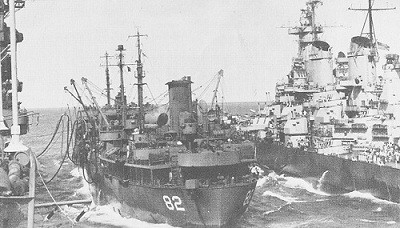 Image of the oiler Cahaba fueling the battleship Iowa and the carrier Shangri-La on a smooth day.