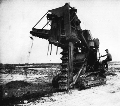 Bucket Ditcher Excavating Drainage Trench to Handle the Tropical Rains of Peleliu Island. 