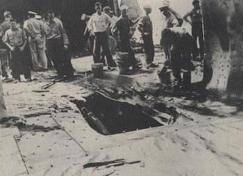 Hole in deck of Chester caused by bomb hit on February 1, 1943