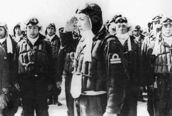 A Japanese kamikaze pilot salutes on receiving his sortie orders