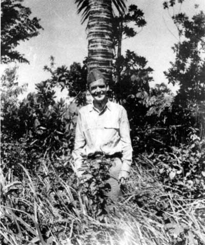 Lieutenant Bob Wallace poses in the jungle on Guam