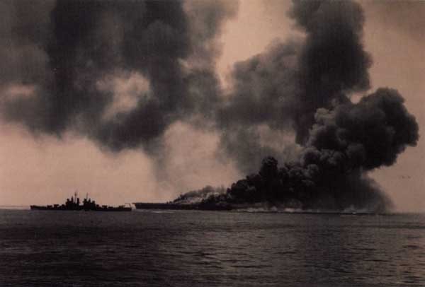 Smoke billows into the sky from Bunker Hill (CV 17) after a kamikaze attack during the Okinawa operation