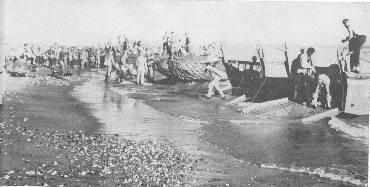 THE ARMY ARRIVES. Commencing in mid-October, Army ground units began to reach Guadalcanal. This picture shows elements of the Americal Division hitting Guadalcanal's beaches in late 1942.
