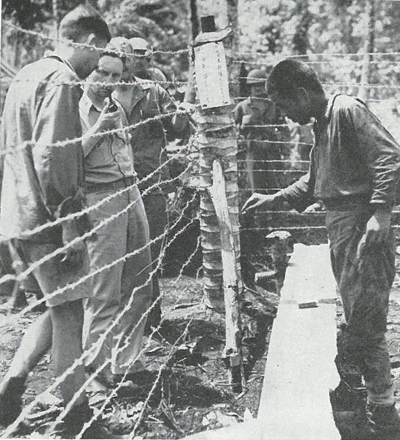 INSIDE THE STOCKADE, a cooperative Japanese prisoner is interrogated by Marine intelligence officers.
