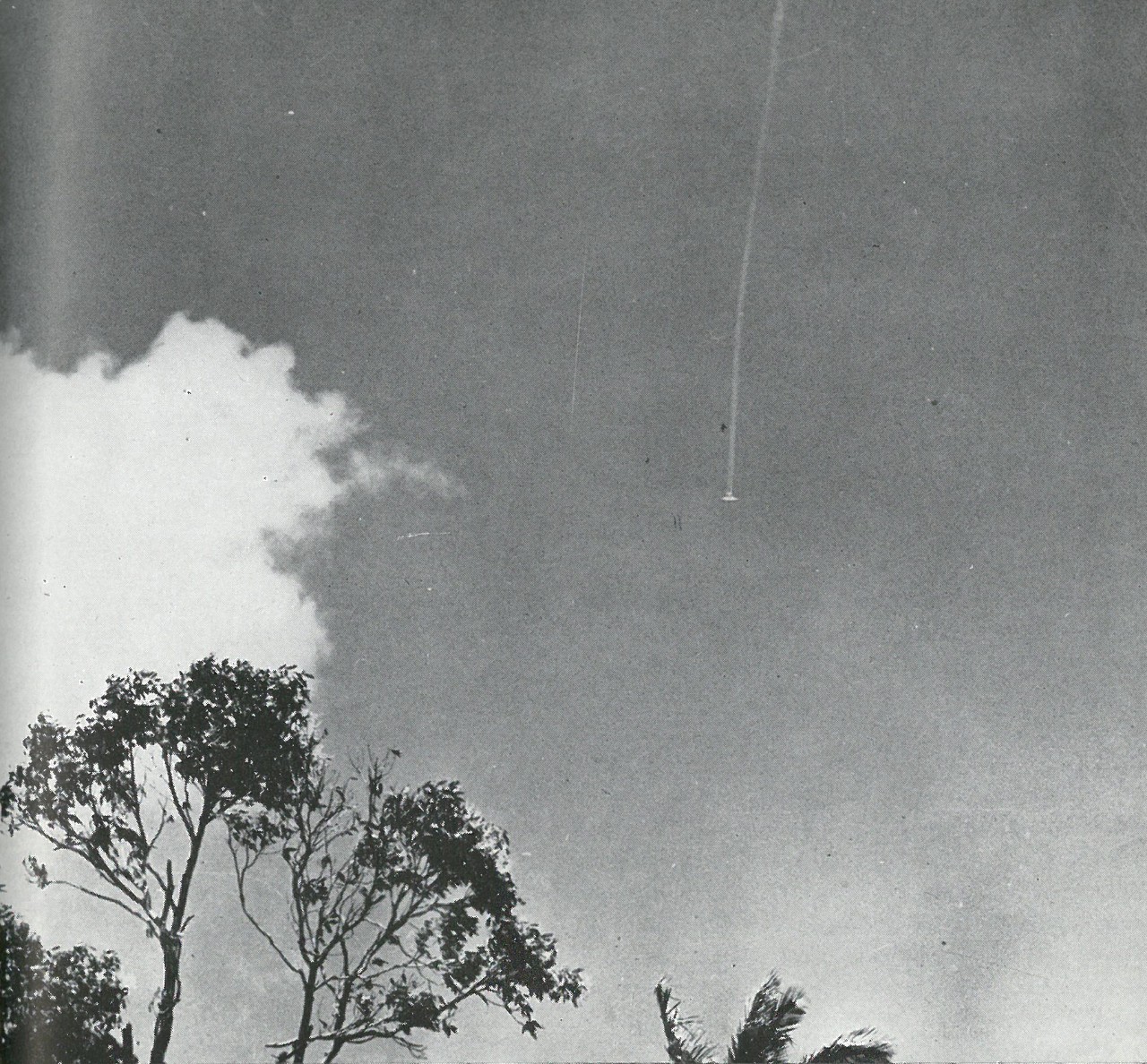 PLUMMETING DOWN, this Japanese bomber has just been hit by Grumman Wildcat fighters of the 1st Marine Air Wing.