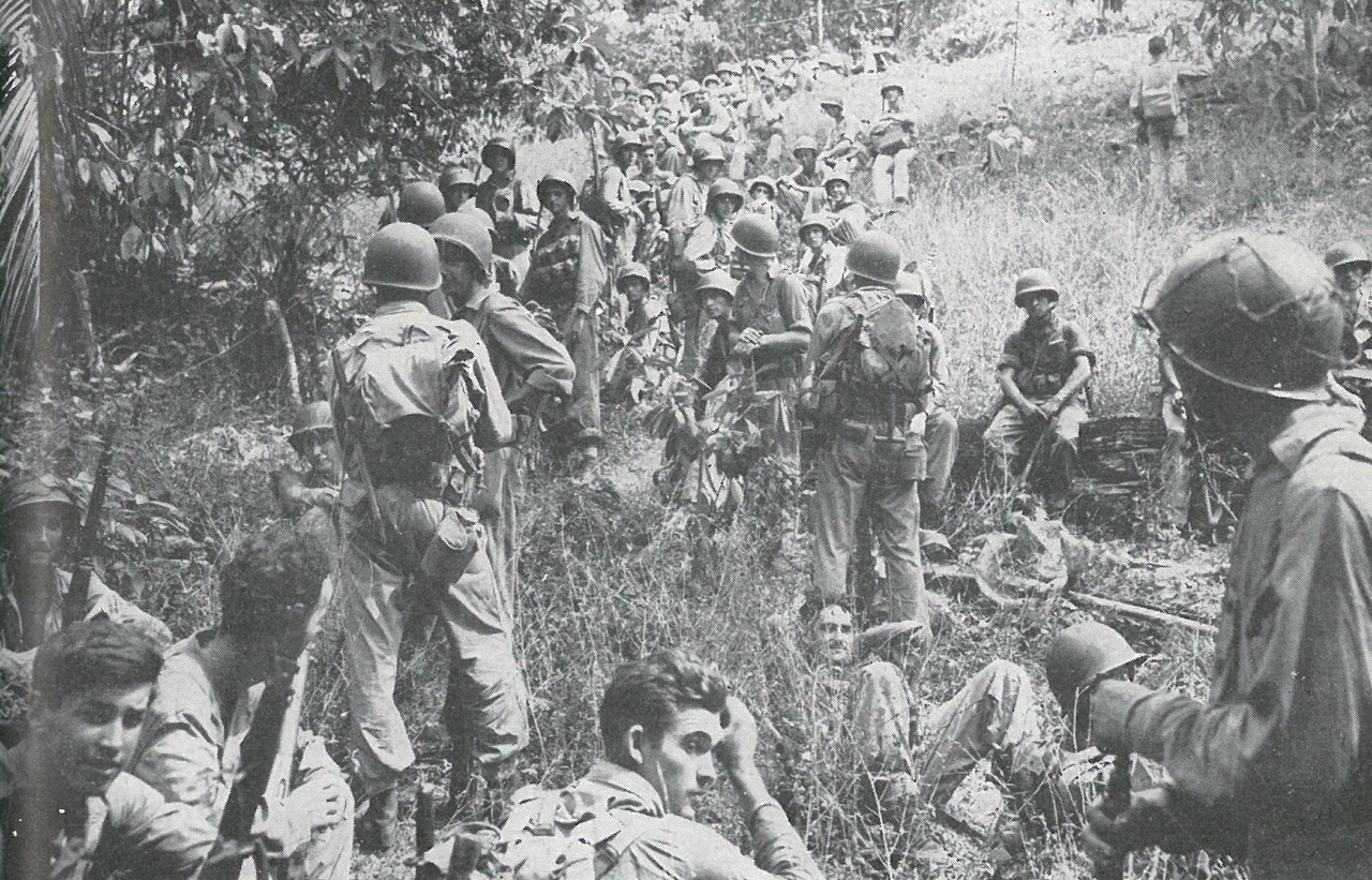 ADDITIONAL UNITS ARRIVE. Fresh troops from the 2d Marine Division during a halt. Note clean-shaven faces and good condition of equipment and clothing.