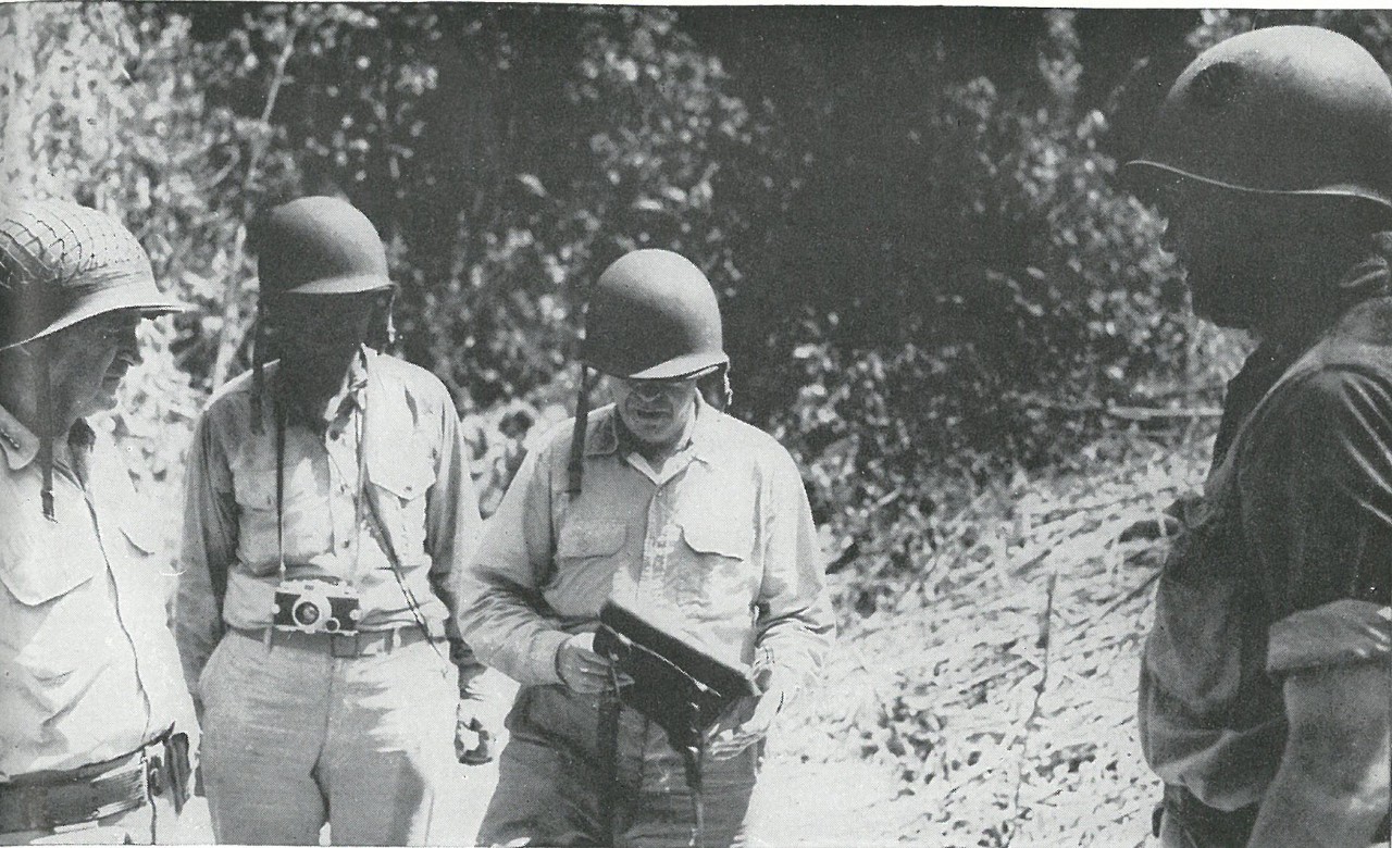 THE COMMANDANT INSPECTS. Third from left, LtGen Thomas Holcomb, seventeenth Commandant of the Marine Corps, looks over a captured Japanese despatch-case during his front-line inspection of Guadalcanal in October 1942.