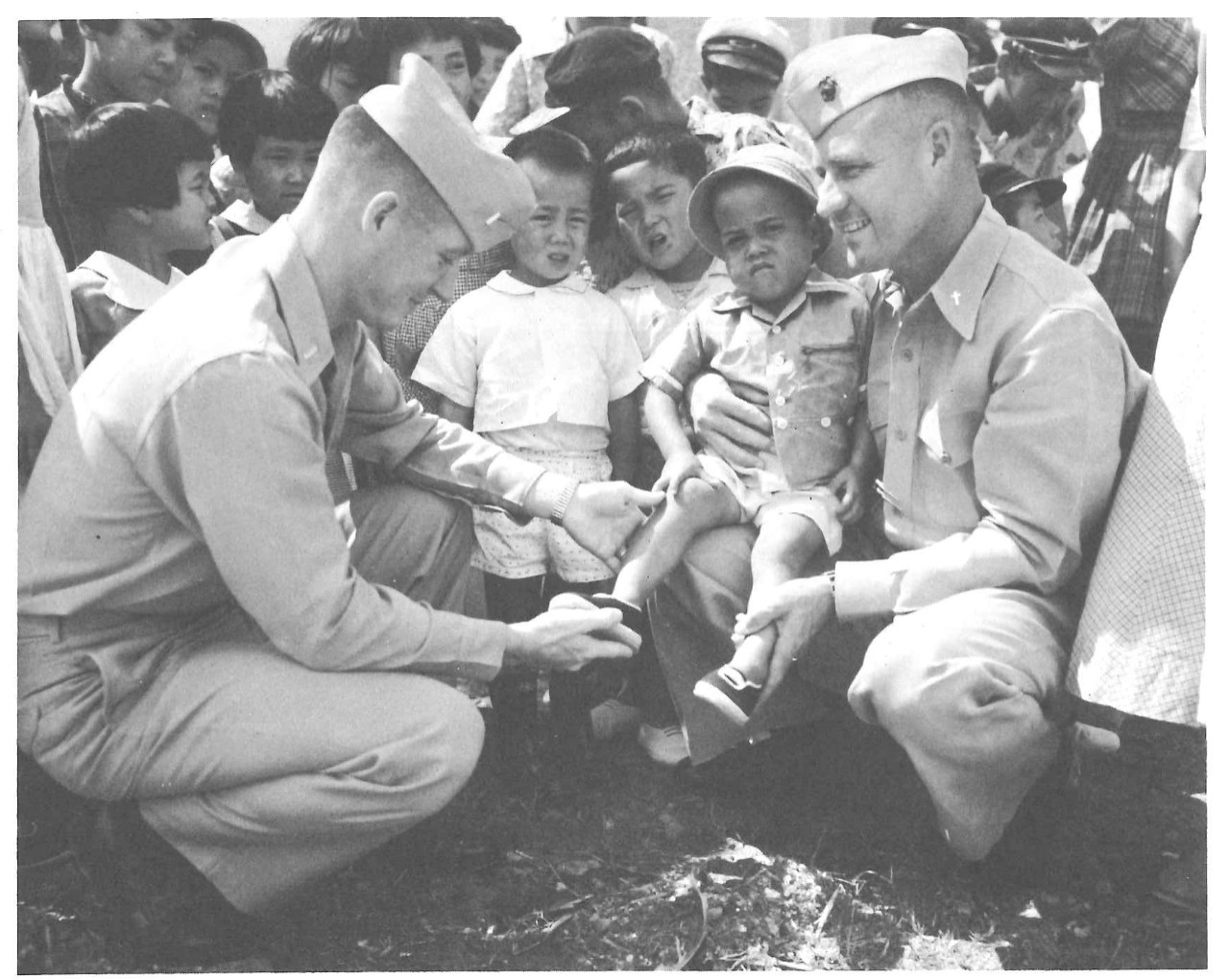 Two Navy men with children