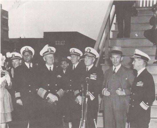 Rear Admiral Byrd greeted at Washington Navy Yard upon his return from Antarctica. He is flanked by Fleet Admiral Chester Nimitz and Secretary of the Navy James Forrestal.