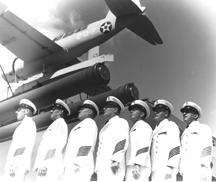 Image - row of Chief Petty Officers with an airplane in the backgroound