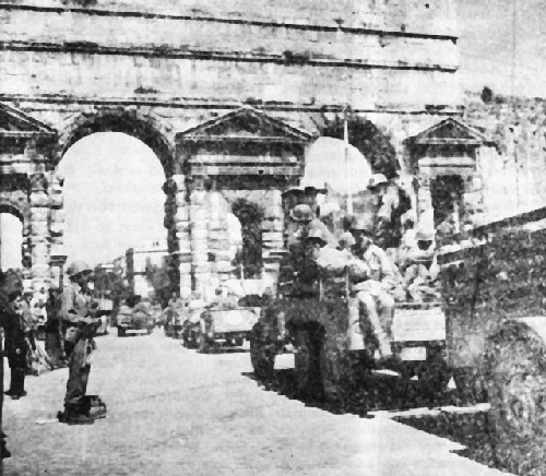 Image: Sgt. Jimmy Declay, Apache, stands guard at the gateway to Rome as the U.S. Army enters the city.